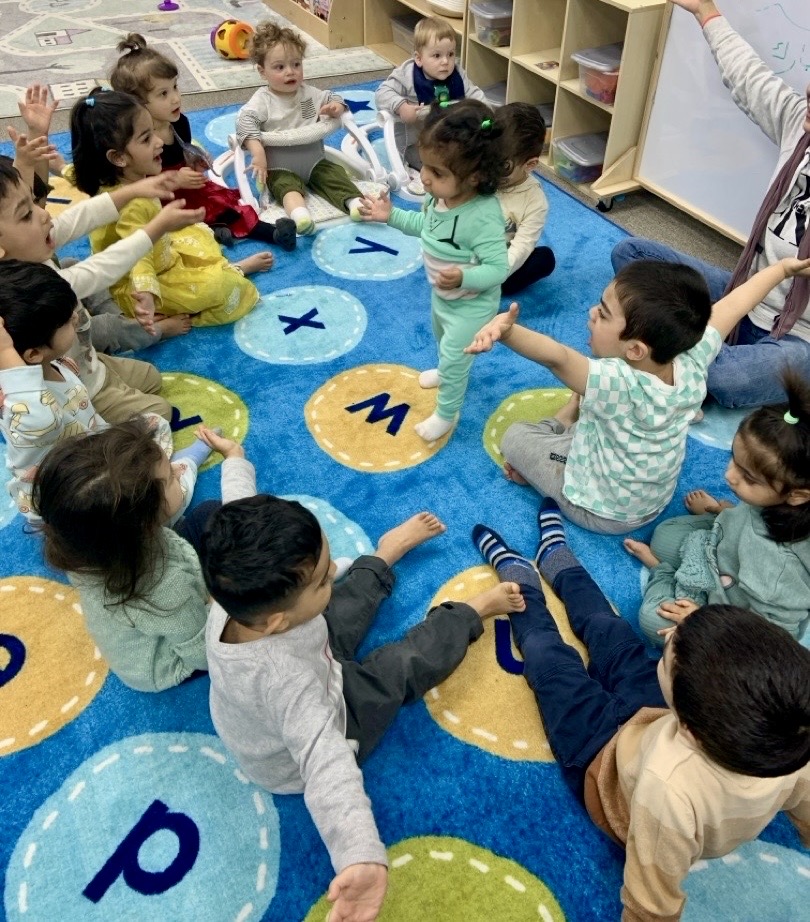 Children gathered on the carpet together at Little Muslims