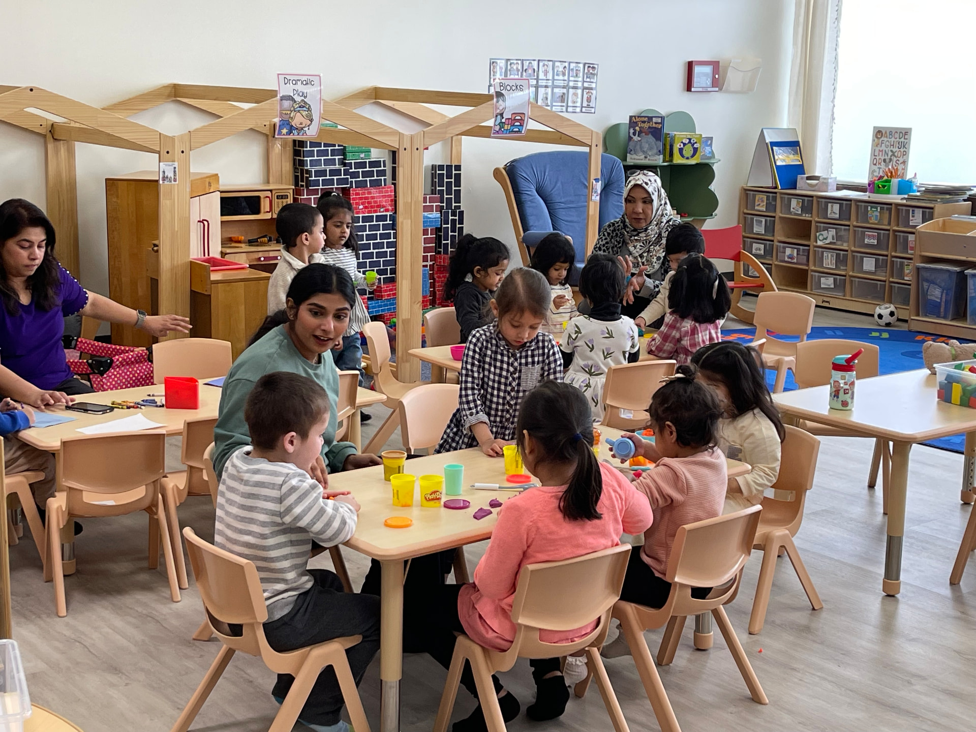 Little Muslims teachers and children playing together